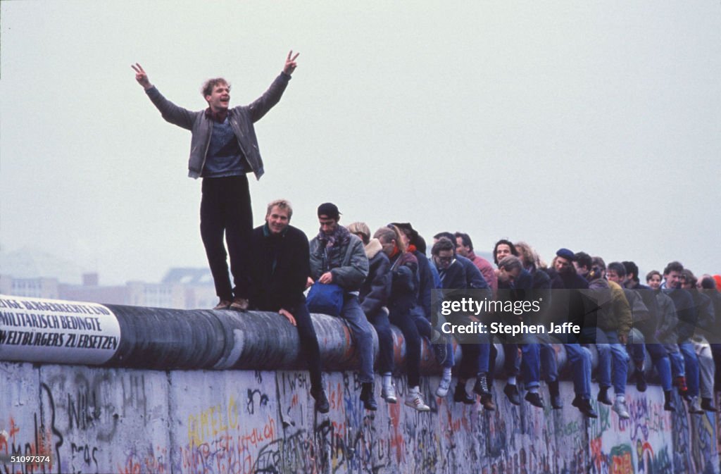 West Germans Celebrate The Unification Of Berlin Atop The Berlin Wall During The Collaps...