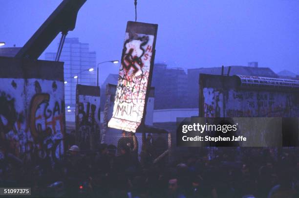 Lone Light Illuminates A Piece Of The Berlin Wall Being Lifted During The Collapse Of Communism In East Berlin On November 12, 1989. November, 1999...