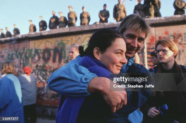 West German Couple Embraces In Front Of The Berlin Wall Prior To It Being Lifted During The Collapse Of Communism In East Berlin On November 10,...