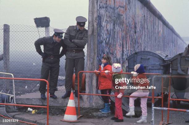 West German School Children On The Way To School Come Across The Berlin Wall Being Opened With Two East German Border Guards During The Collapse Of...
