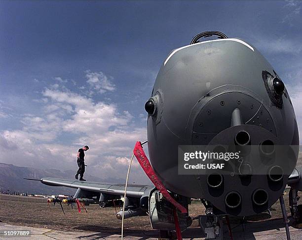 Airman 1St Class Jason Acheson, A-10 Thunderbolt Crewchief Does A Post-Flight Check Of An A-10 After It Was Flown Against Targets In Yugoslavia On...
