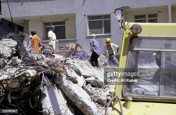 Rescue Teams Work To Find Survivors Under The Rubble Of Concrete Buildings Which Collapsed In The City Of Istanbul During The Earthquake That Shook...