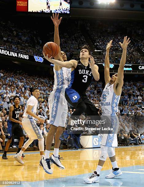 Grayson Allen of the Duke Blue Devils drives to the basket against teammates Brice Johnson and Marcus Paige of the North Carolina Tar Heels during...