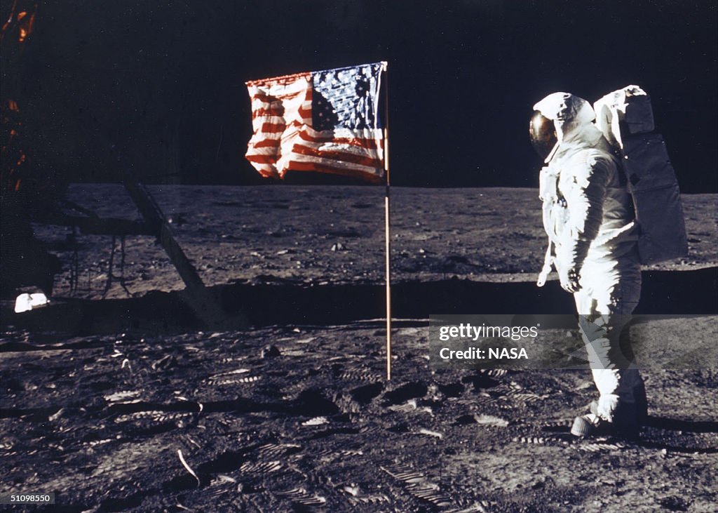 Astronaut Edwin E Aldrin Jr Poses For A Photograph Beside The Deployed Flag Of The United States