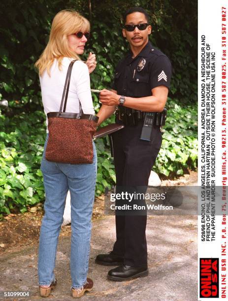 Encino, Los Angeles, California. Neighbour And Friend Andrea Diamond Is Questioned By Police Out Side The Home Of Phil And Brynn Hartman Who Died In...