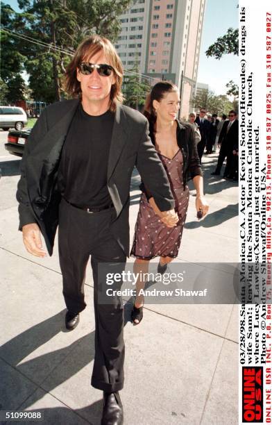 Santa Monica,Ca. Actor Kevin Sorbo Drags His Wife Sam By The Hand, Leaving The Santa Monica Catholic Church, Where Lucy Lawless Had Just Got Married.