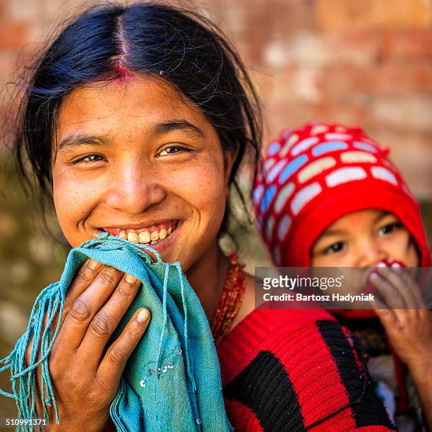 young nepali woman carrying her baby - nepali mother stock pictures, royalty-free photos & images