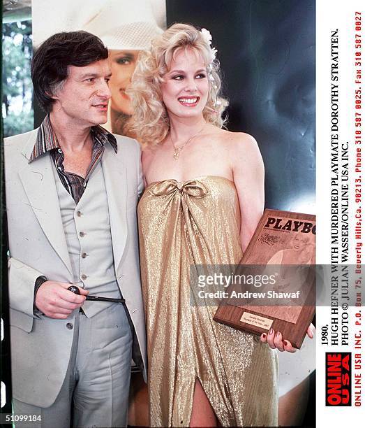 American pornographer Hugh Hefner and murdered Playboy PLaymate Dorothy Stratten , 1980. She holds a plaque naming her 1980 Playmate of the Year.