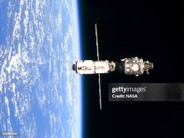 The International Space Station Is Backdropped Against The Blue And White Horizon Scene Of Earth And The Blackness Of Space Following Separation From...
