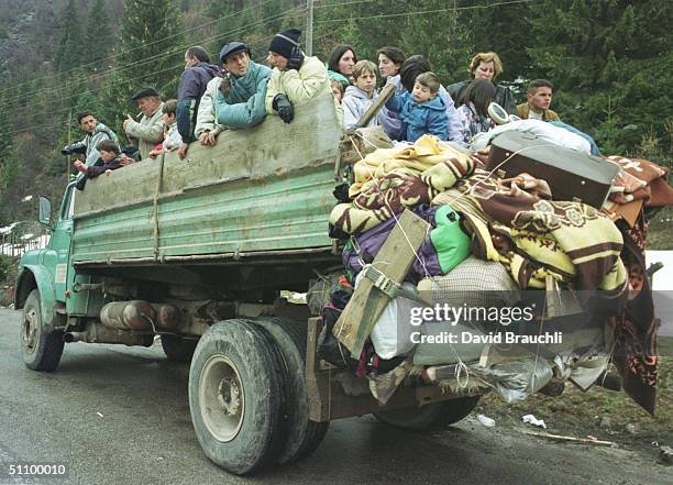 Kosovars From Pec Wait Atop A Truck On A Mountain Road Leading From The Kosovo-Montenegro Border Monday March 29, 1999 After Being Forced To Flee Pec...