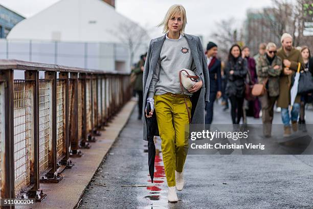 Linda Tol wearing a mustard yellow pants a grey sweater and a dark grey wool coat seen outside Coach during New York Fashion Week: Women's...