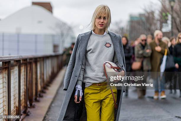 Linda Tol wearing a mustard yellow pants a grey sweater and a dark grey wool coat seen outside Coach during New York Fashion Week: Women's...