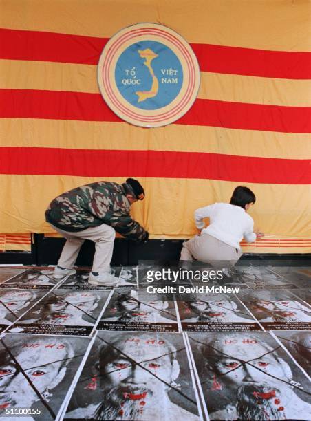 Westminster, California:21Feb99 - American Vietnamese Anti-Communist Demonstrators Tihn Nguyen And Thu Nga Secure A South Vietnamese Flag That Covers...