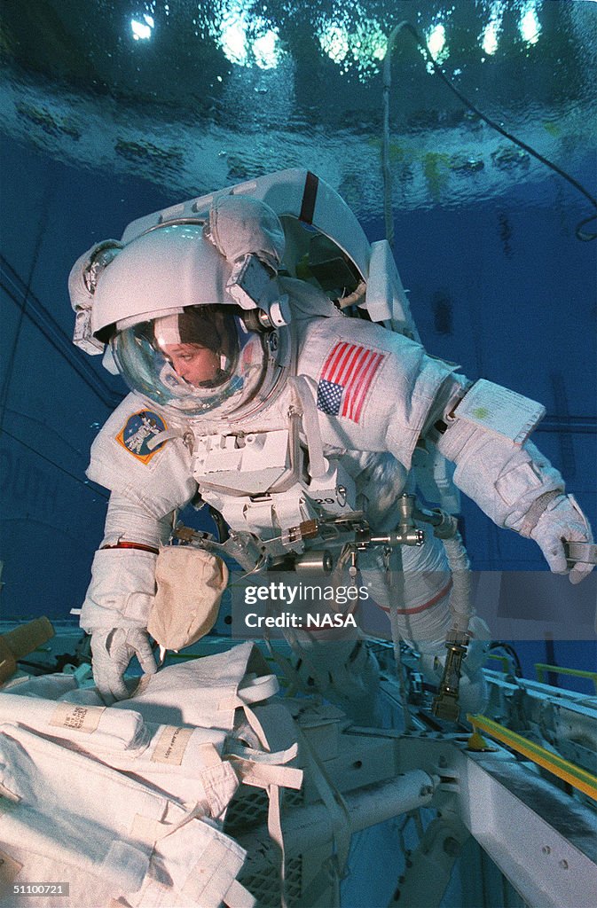 Astronaut Tamara E. Jernigan, Mission Specialist, Uses A Special Tool