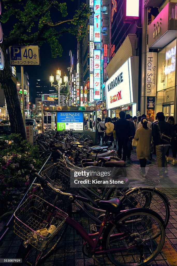 Row of bikes at night in Tokyo City, Japan