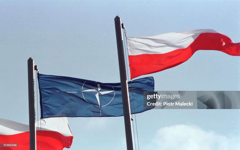 NATO And Polish Flags In Front Of The Polish Parliament Building As An Official Sign That Poland Is