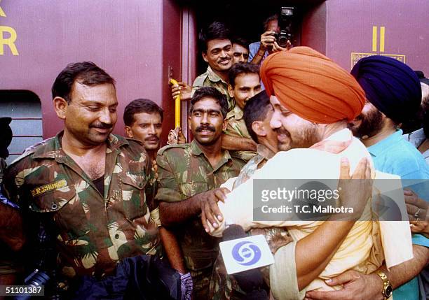 Indian Punjabi Pop Star Daler Mehandi Hugs An Indian Army Soldier At A Railway Station In New Delhi July 6, 1999 Before Their Departure To The Kargil...