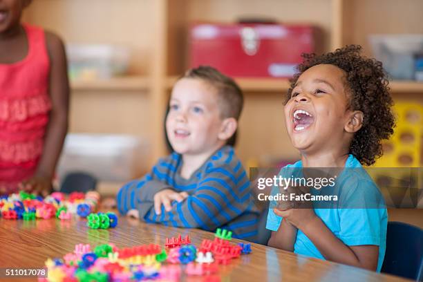 laughing together in class - nursery school stockfoto's en -beelden