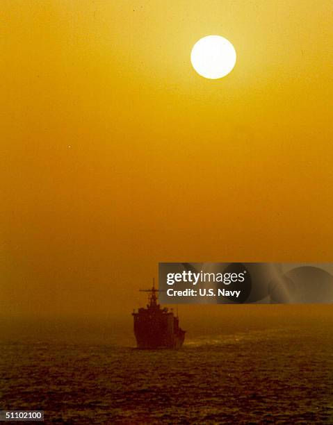 The Dock Landing Ship USS Harpers Ferry Cuts A Path Through The Arabian Gulf At The Start Of A New Day March 4, 1999 As The Sun Rises Behind. The...