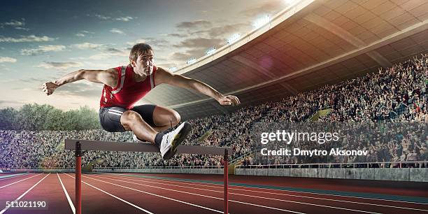 male athlete hurdling on sports race - hordelopen atletiekonderdeel stockfoto's en -beelden