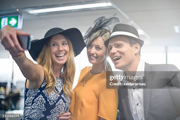 selfie moment from the melbourne cup party - horse racing australia stock pictures, royalty-free photos & images