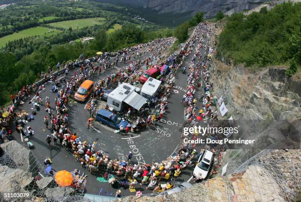 Hundreds of thousands of fans crowd the course as Lance Armstrong of the USA and riding for US Postal Service presented by Berry Floor climbs Alpe...