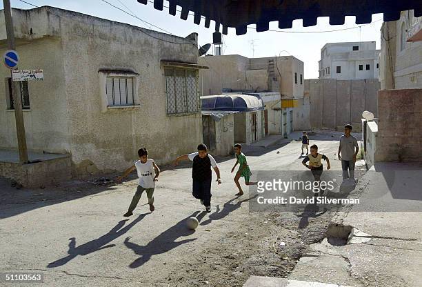 palestinians live in village divided by israel's west bank barrier - poor kids playing soccer stock pictures, royalty-free photos & images