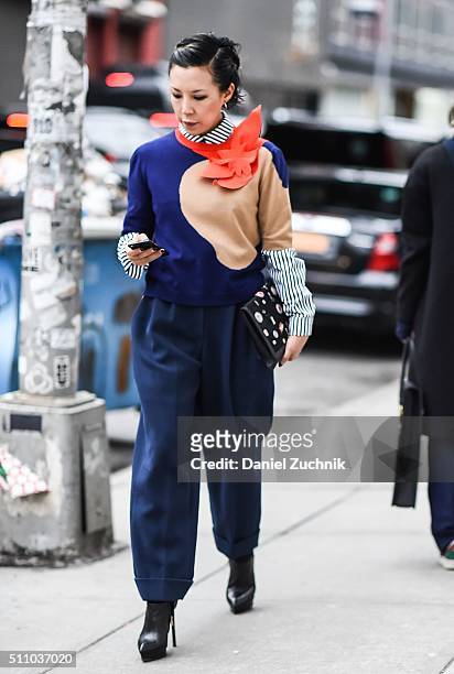 Jeannie Lee is seen outside the DKNY show wearing a striped shirt, 3d graphic sweater and blue pants during New York Fashion Week: Women's...
