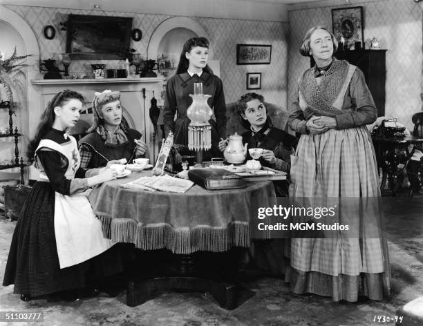 Actresses Margaret O'Brien, Elizabeth Taylor, June Allyson, Janet Leigh, and Lucile Watson in character as the March women drinking tea on the set of...