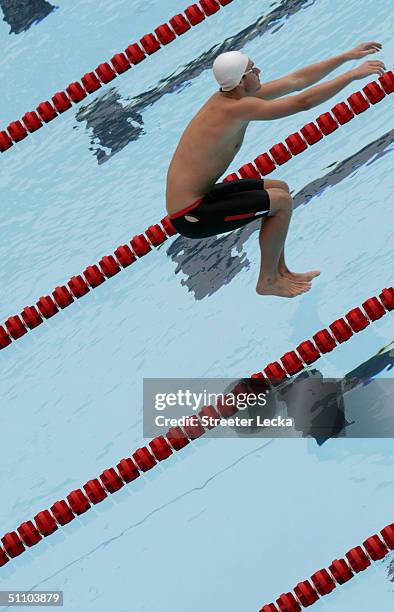 Aaron Peirsol jumps in the pool before swimming the 100 meter backstroke prelim during the US Swimming Olympic Team Trials on July 8, 2004 at the...