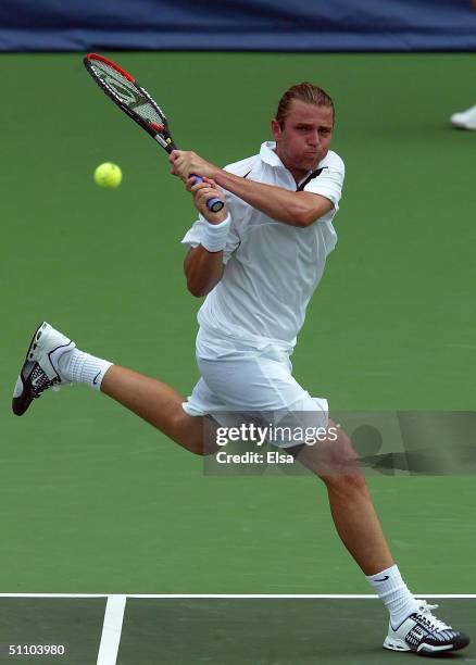 Mardy Fish of the USA returns a shot to Gregory Carraz of France during the RCA Tennis Championships on July 21, 2004 at the Indianapolis Tennis...