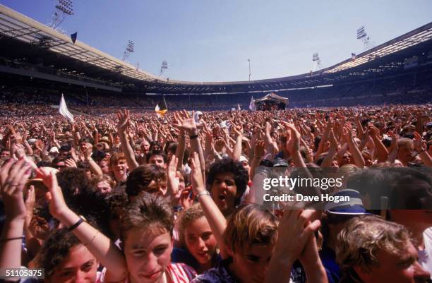 View of the crowd at the Live Aid charity concert, Wembley Stadium, London, 13th July 1985.