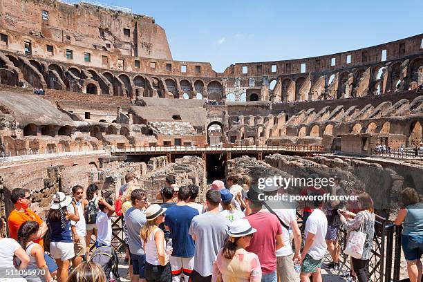 tourists at the colosseum in rome, italy - rome tourist stock pictures, royalty-free photos & images