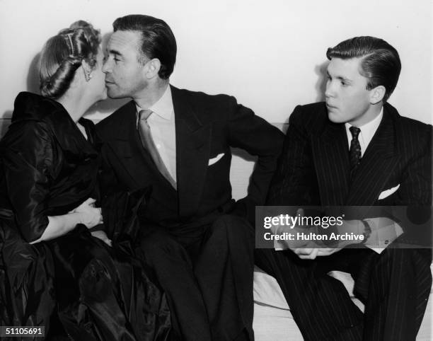 At their wedding reception, American socialite and Woolworth's heiress Barbara Hutton and Dominican diplomat and socialite Porfirio Rubirosa kiss...