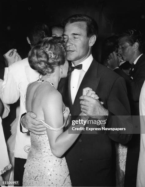 Dominican diplomat and socialite Porfirio Rubirosa holds onto Athina Mary Livanos , the wife of Aristotle Onassis, as the pair dance very closely at...