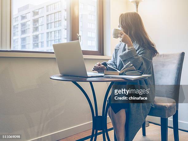 japanese woman working at home - seattle coffee stock pictures, royalty-free photos & images