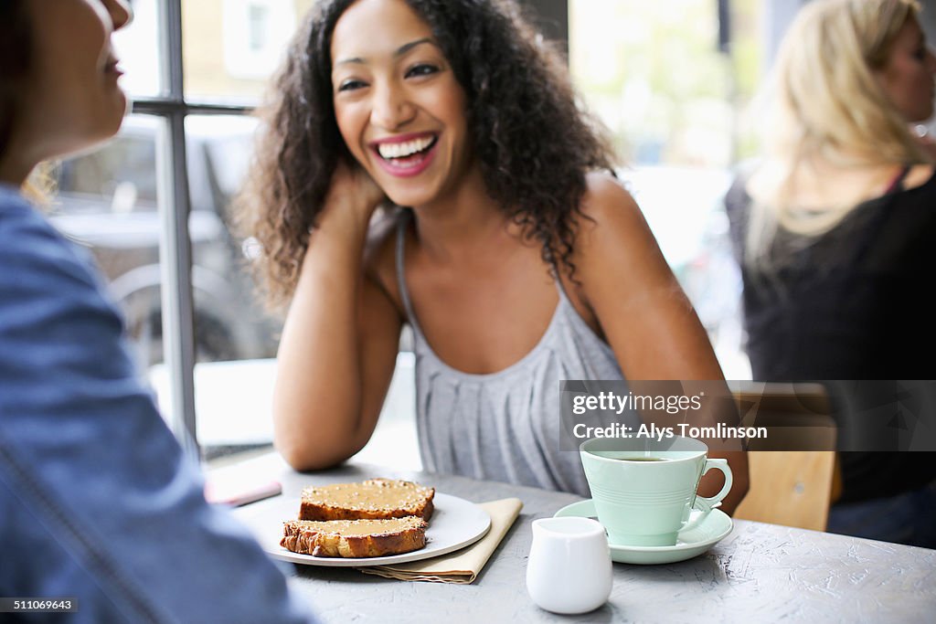 Woman Laughing in a Cafe