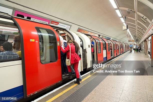 Last passenger to squeeze onto the London Underground train at Tottenham Court Road station.