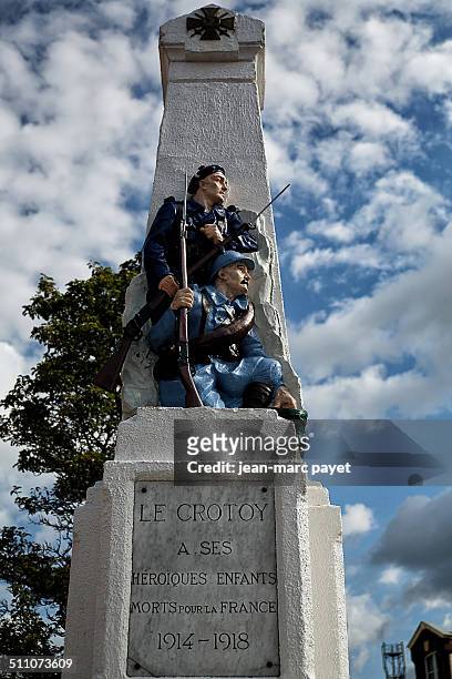 War memorial in the city of Le Crotoy, Bay of Somme, Picardy, France. Obelisk with a bronze relief of two soldiers, world war I 1914-1918