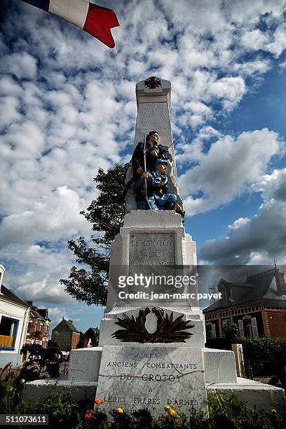 War memorial in the city of Le Crotoy in France, Picardy in the Bay of Somme. Hairy standing holding his rifle in his hand. Obelisk with a bronze...