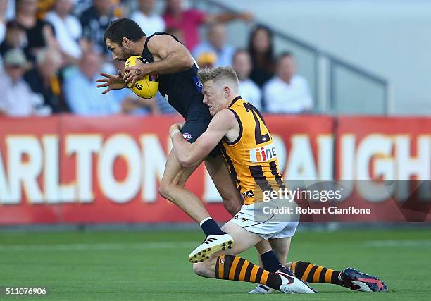 Kade Simpson of the Blues is challenged by James Sicily of the Hawks during the 2016 AFL NAB Challenge match between the Hawthorn Hawks and the...