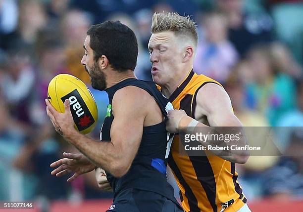Kade Simpson of the Blues is challenged by James Sicily of the Hawks during the 2016 AFL NAB Challenge match between the Hawthorn Hawks and the...