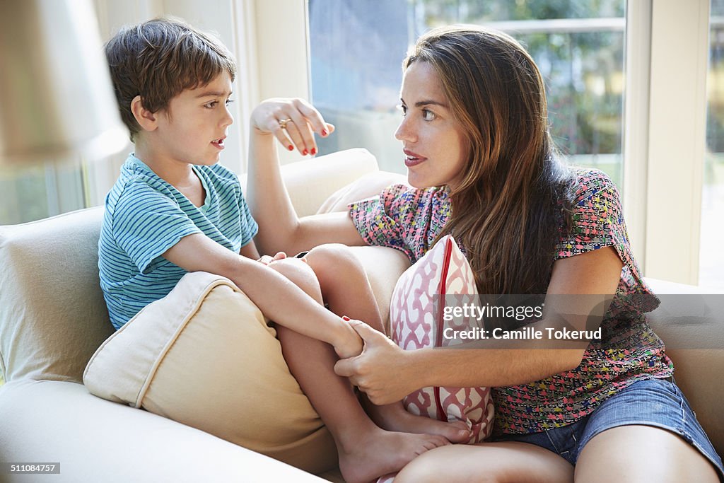 Mother talking to son on the sofa