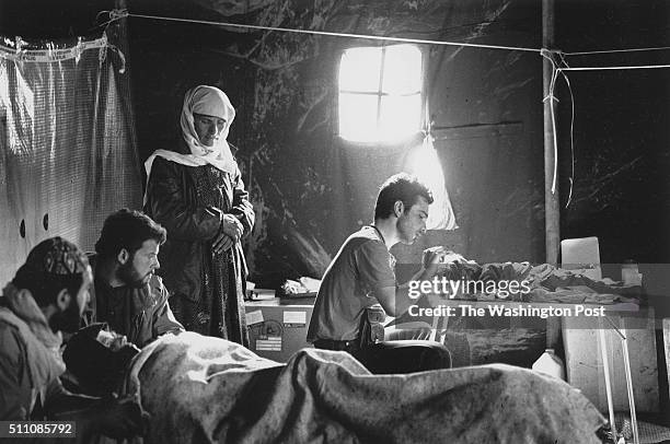 Dutch nurse at Iskiveren refugee camp in Turkey, near the Iraqi border, examines a small Kurdish girl, who died soon after the photo was taken. At...