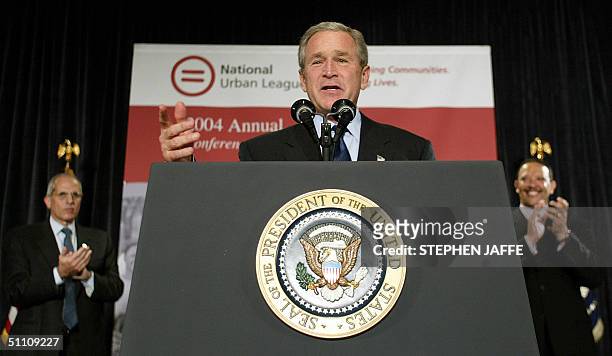President George W. Bush speaks as Michael Critelli , Chairman of the National Urban League, applauds with Marc Morial , the President and CEO of the...