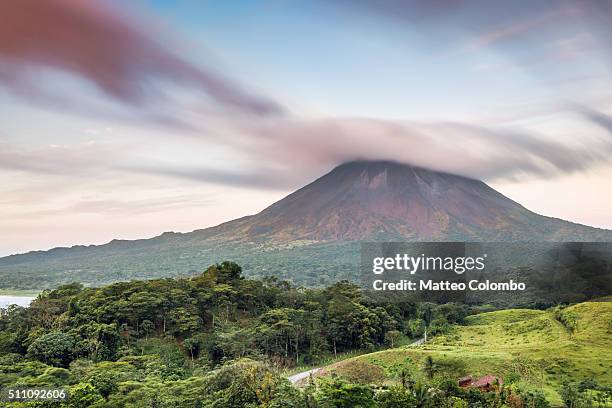 dramatic landscape of arenal volcano at sunset, costa rica - arenal volcano national park stock pictures, royalty-free photos & images