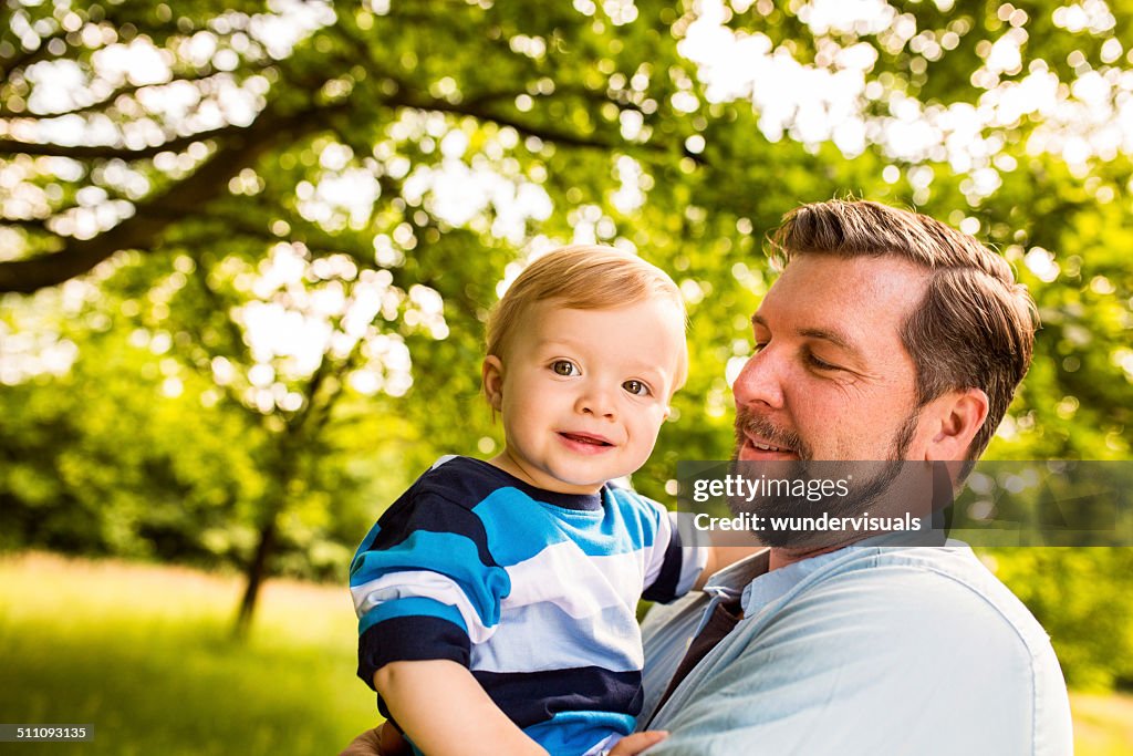Father Holding Boy in Park