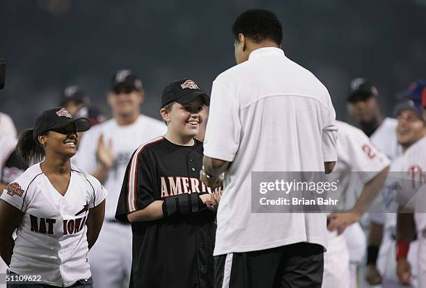 Legendary boxer Muhammad Ali talks with two members of the Boys and Girls Club, before the Major League Baseball 75th All-Star Game between the...