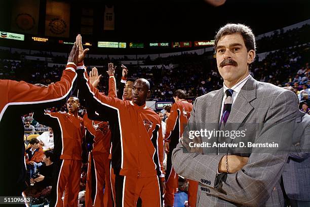 Head Coach Phil Jackson of the Chicago Bulls looks on as Michael Jordan gets introduced prior to a game circa 1990 at the United Center in Chicago,...