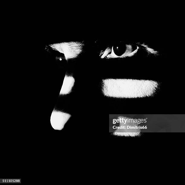 man looking through window blind. high contrast, black & white. - vertical blinds stock pictures, royalty-free photos & images